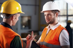 Warehouse workers consulting